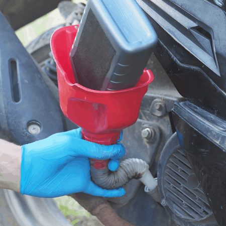 Adding oil to scooter in preparation for a long scooter ride