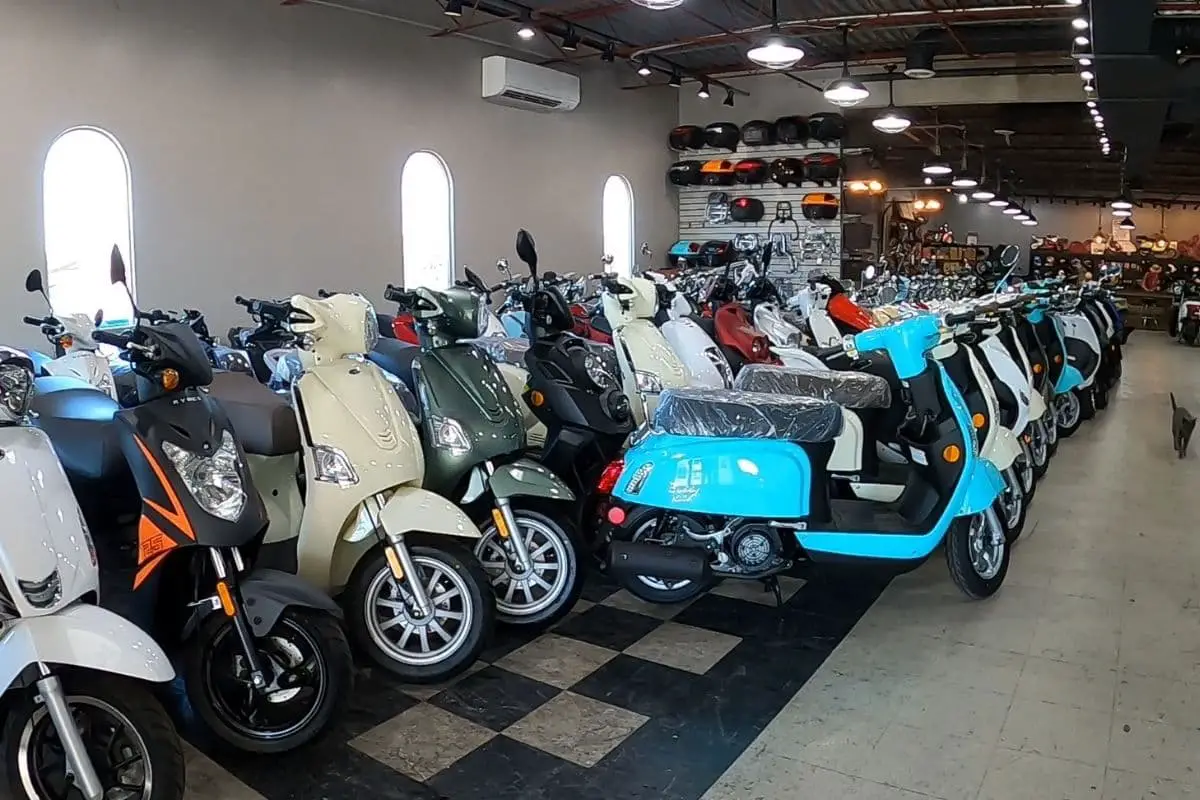 row of scooters for sale inside a dealership