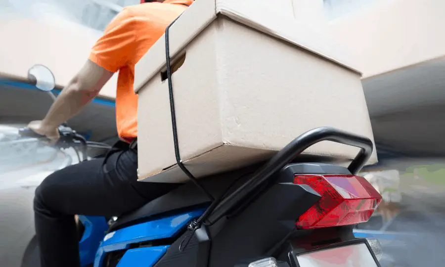 Scooter delivery man with box strapped to rear rack