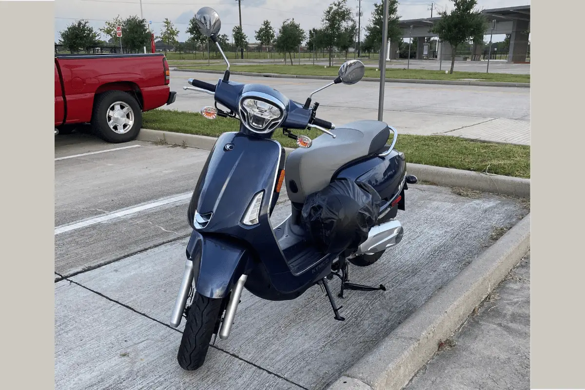 Kymco Like in a parking lot that I purchased - I think Kymco is a good scooter brand!