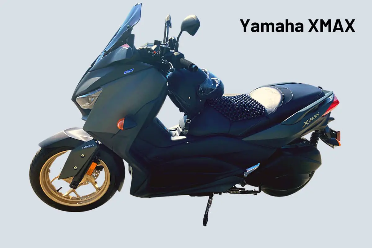 green Yamaha Xmax with a helmet on the seat