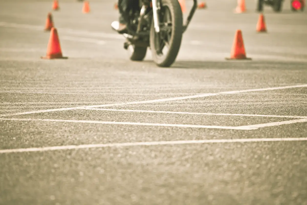 motorcycle wheels in parking lot riding with cones presumably to practice for a test