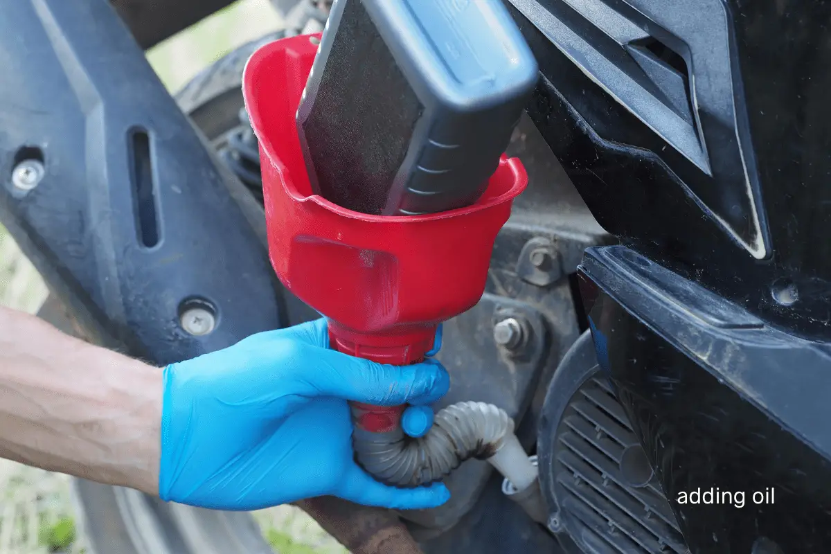 adding oil to a moped