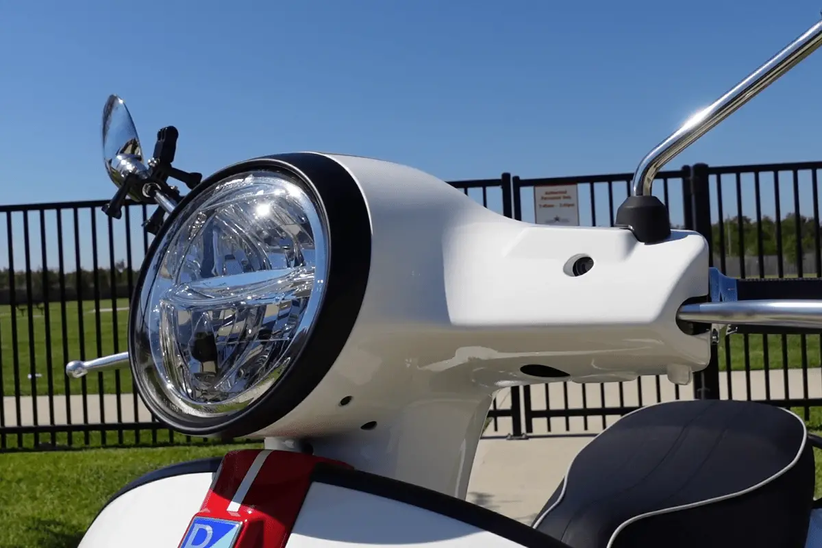 Vespa GTS 300 front headlight close-up in the day time.