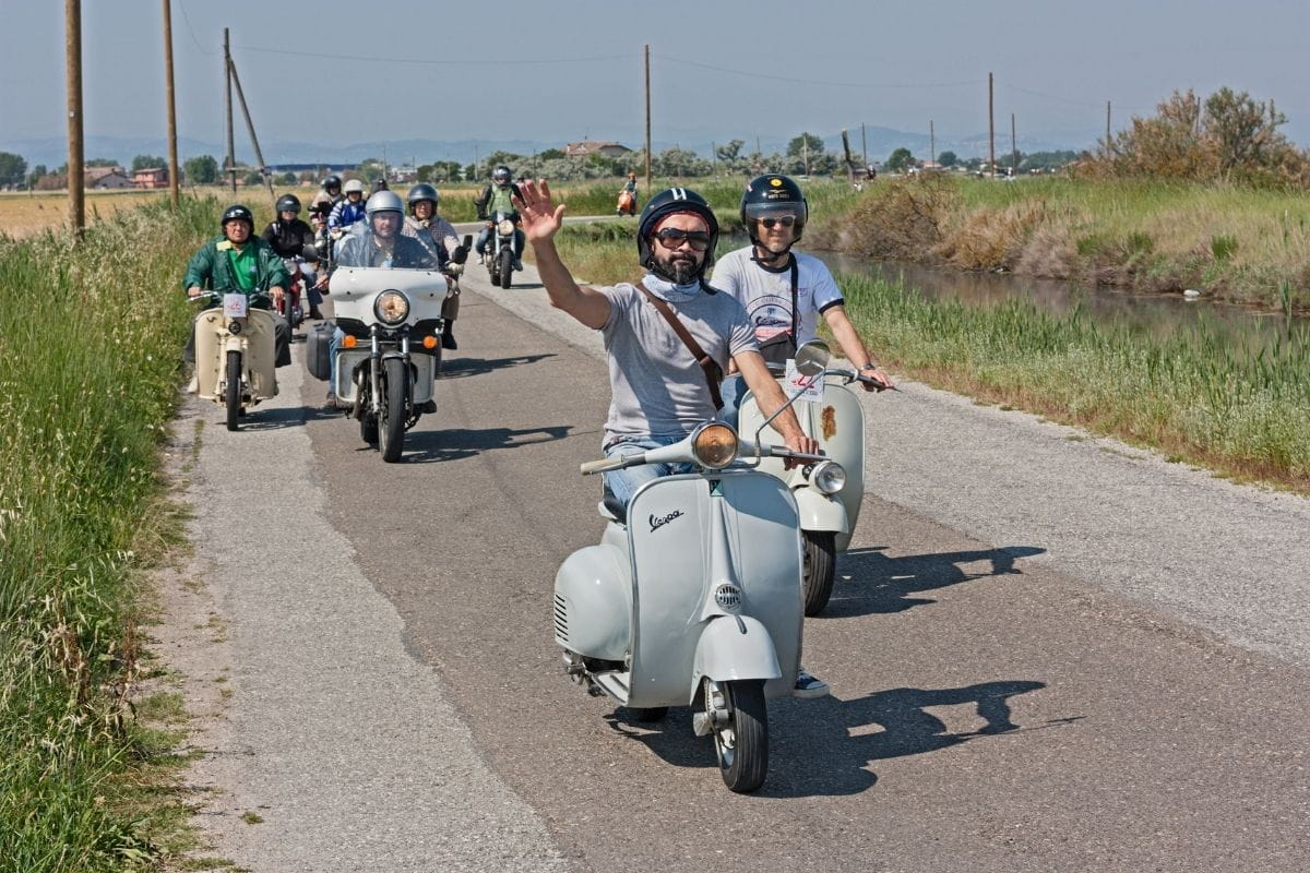 group of riders riding on a country road