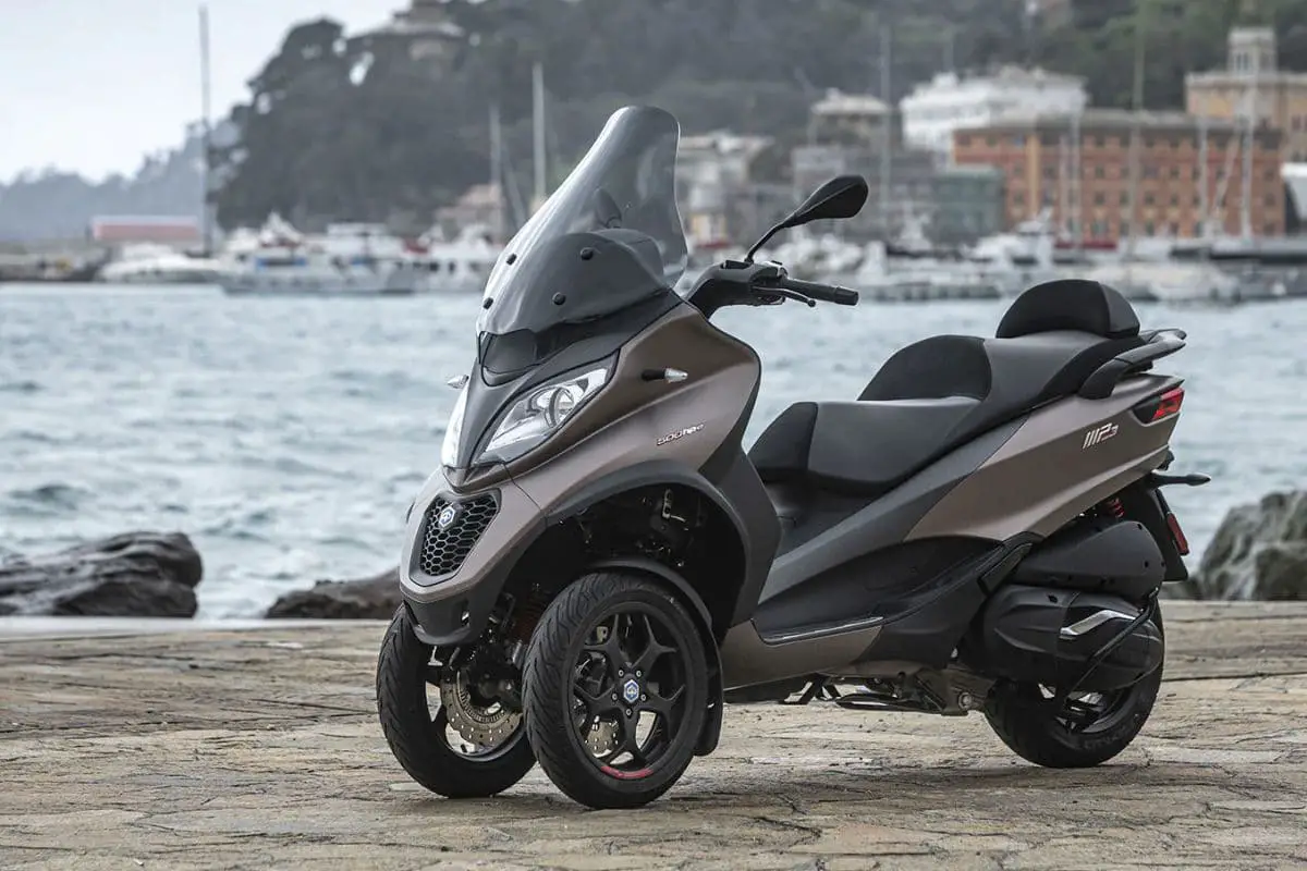 3 wheeled Piaggio MP3 in a bronze-like color