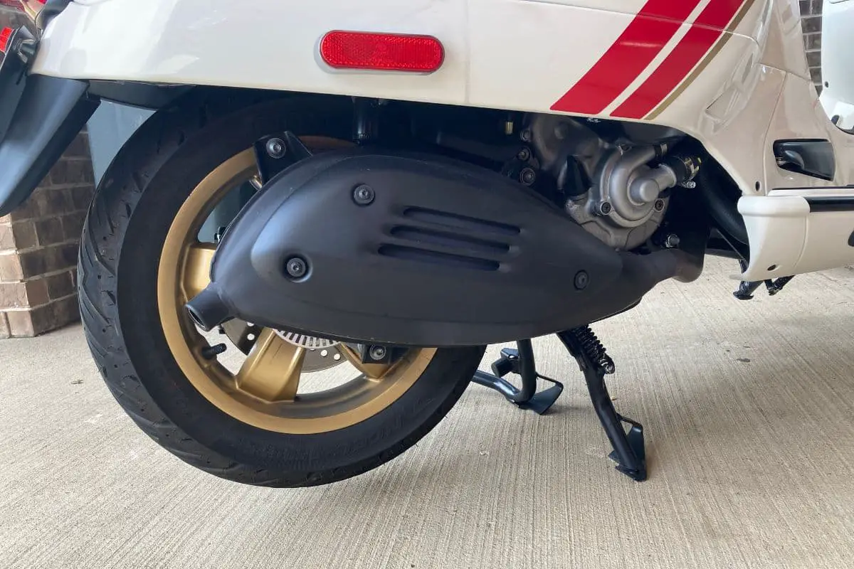 Rear tire of a Vespa that is on its center stand to spin the tire more easily