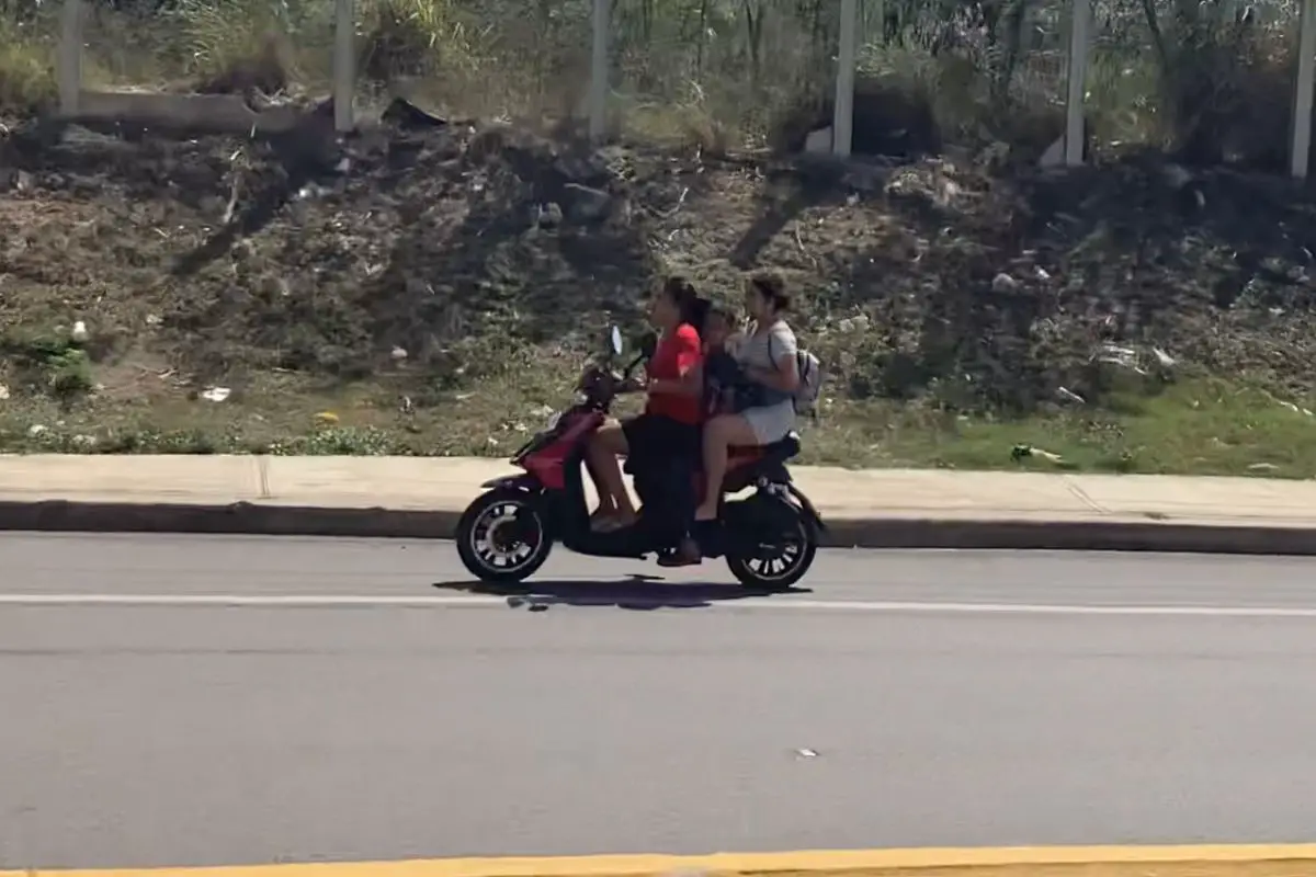 woman driving with a child and another woman passenger