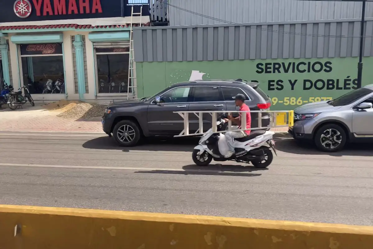 scooter rider carrying a scooter in the Dominican Republic