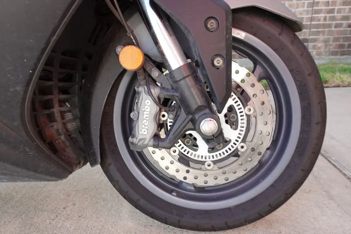 front tire of the AK550 with the brembo components that would need to be inspected when preparing for a scooter rally