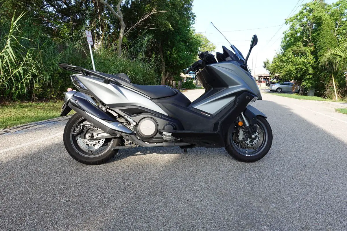 right side view of matte gray Kymco AK550 on a road