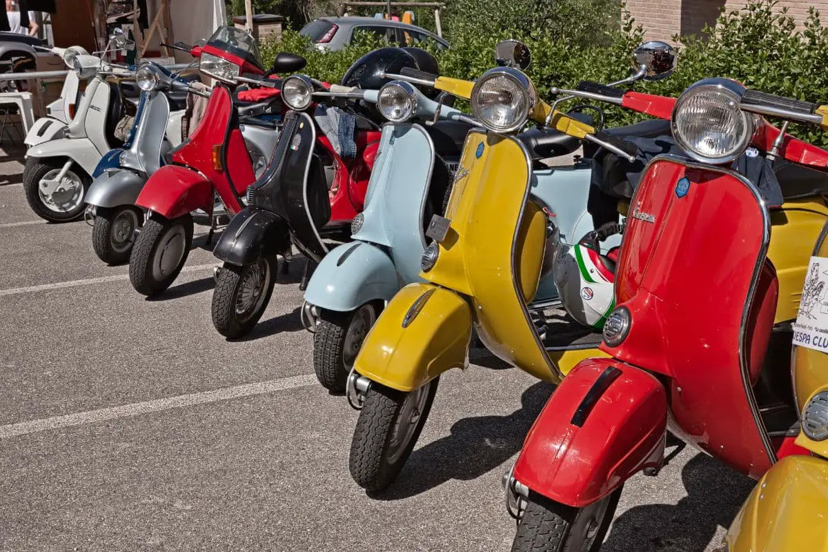 Row of vintage Vespas at a scooter rally
