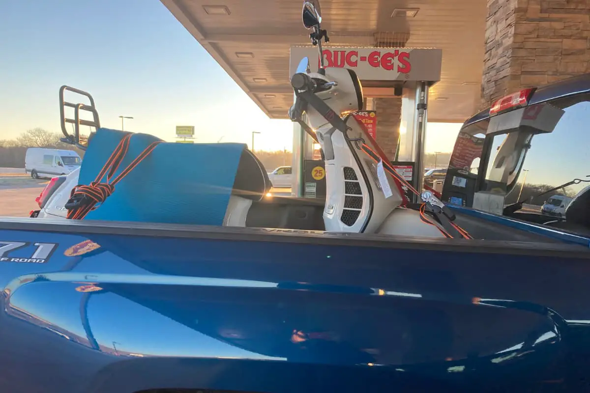 Vespa scooter in back of truck with standard ratchet straps and a bar harness called Canyon Dancer